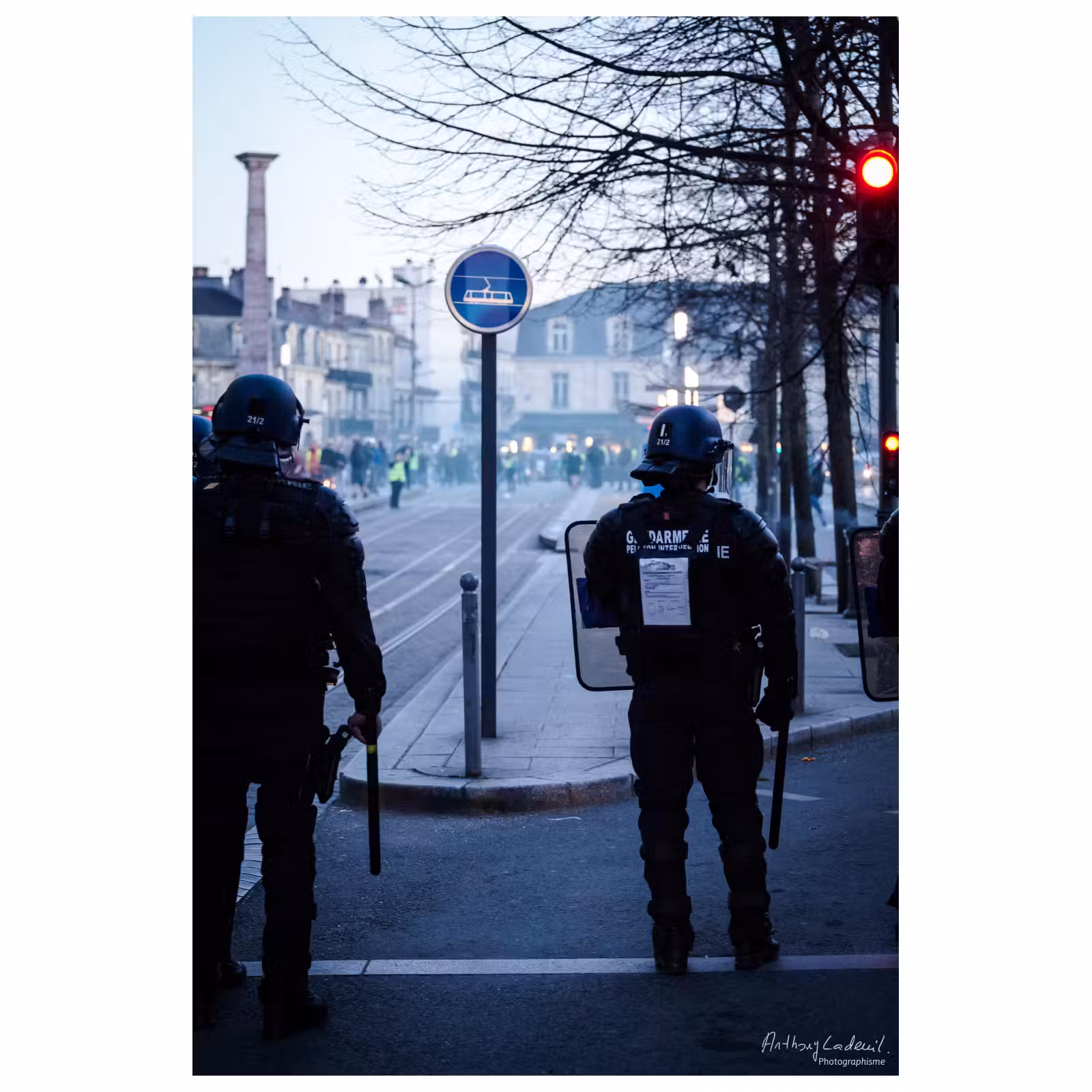 policiers de dos dans des fumées lors d'une manifestation