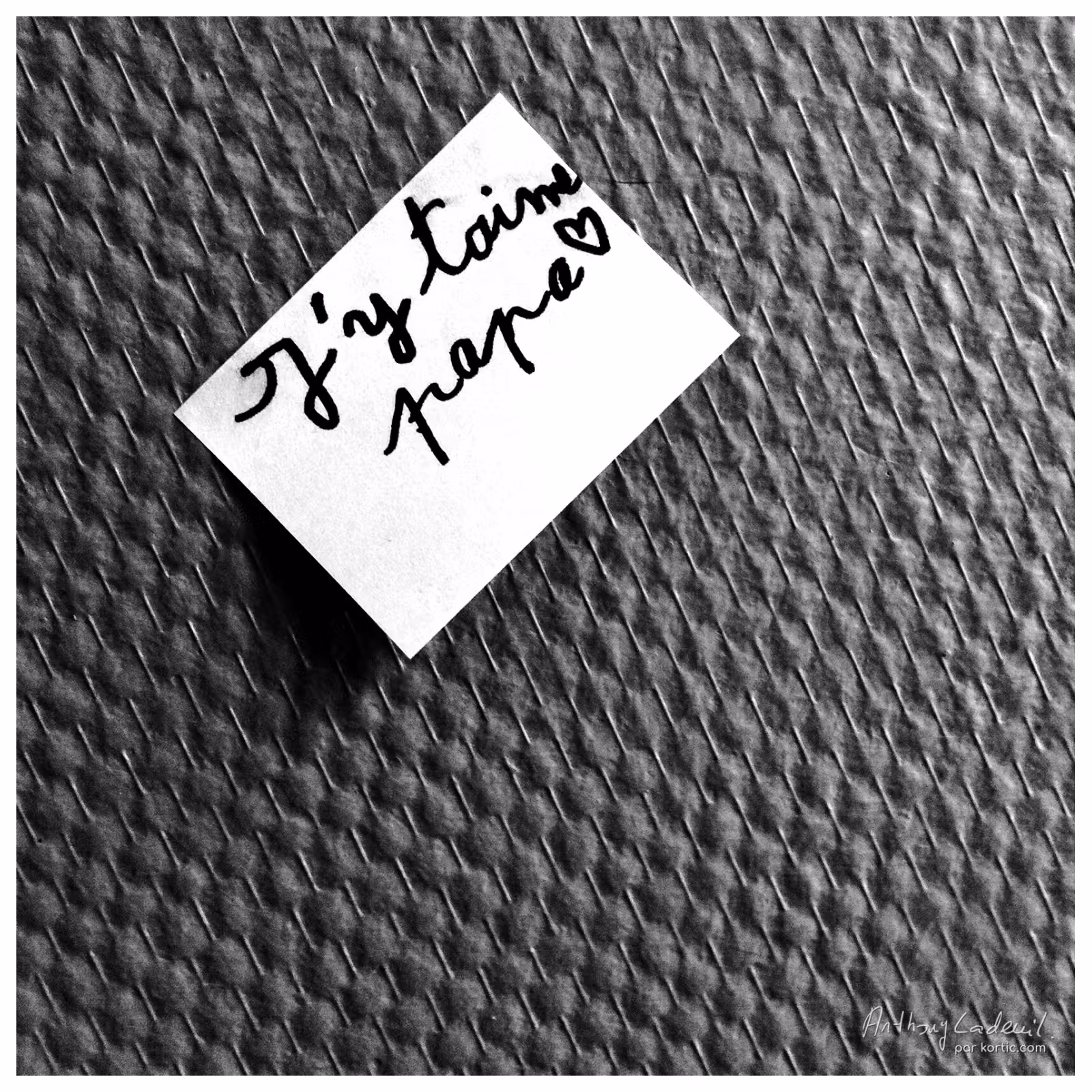 mots écrits par un enfant sur un post it collé au mur