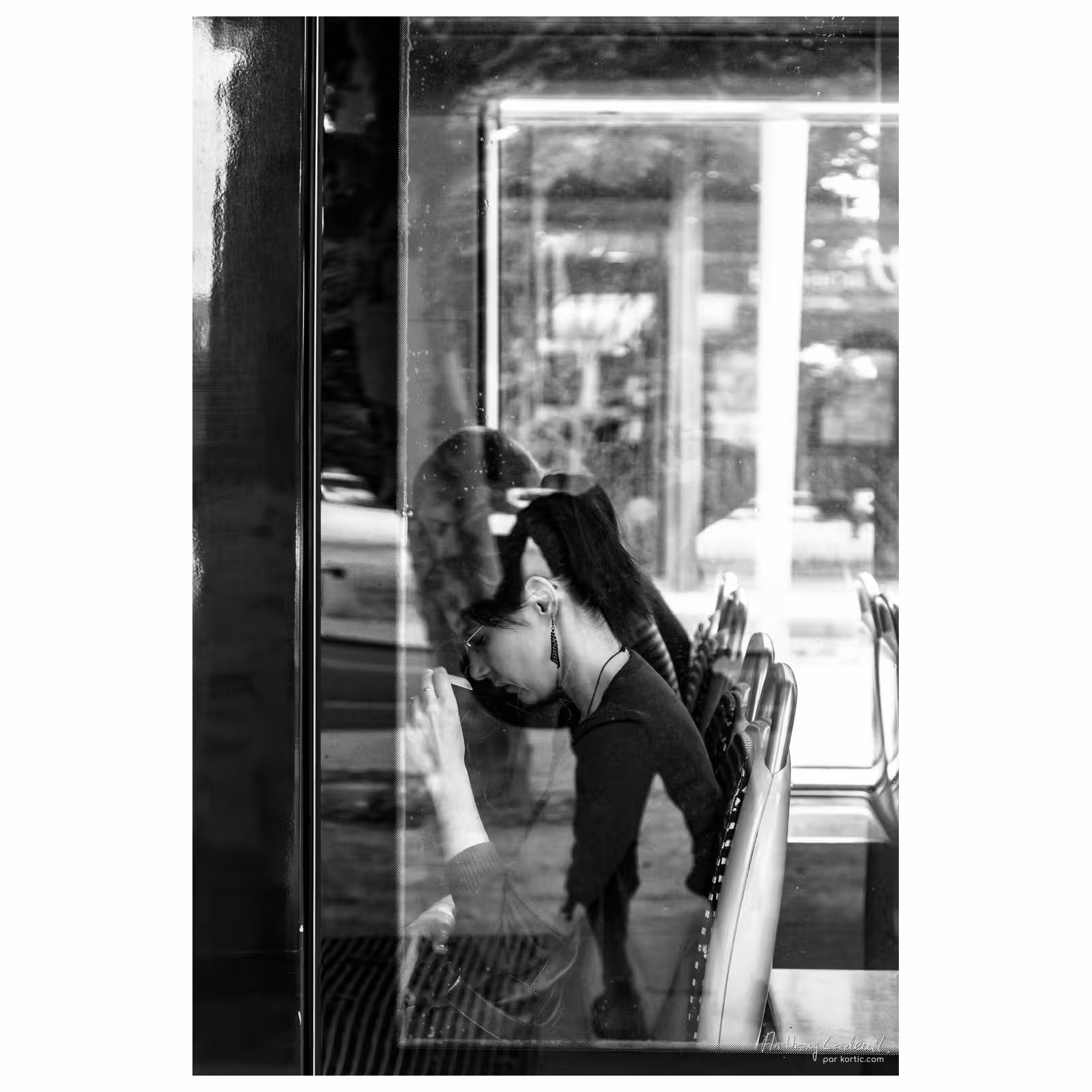 vue d'une jeune femme au travers de la vitre d'un tramway