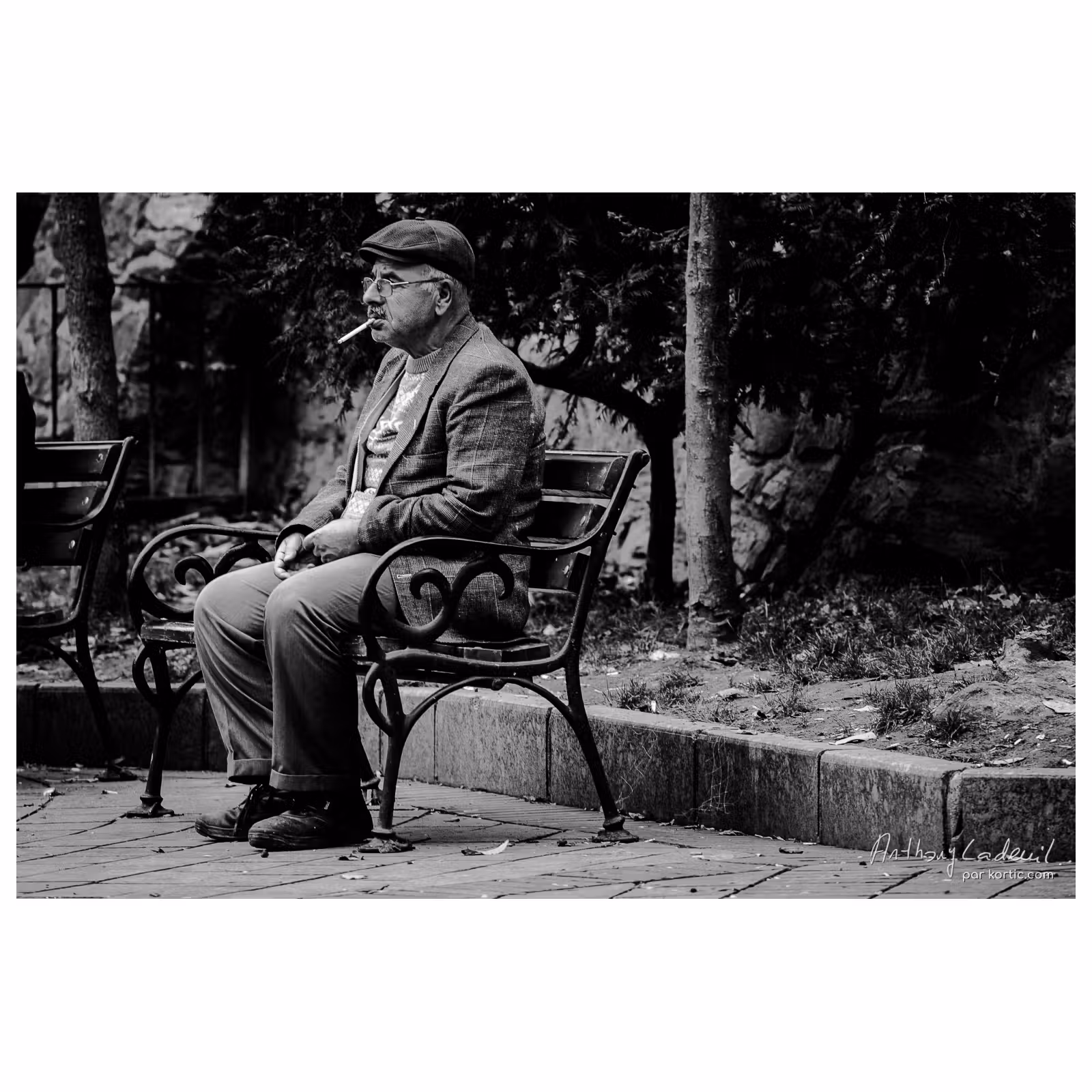 homme qui fumme assis sur un banc à Istanbul