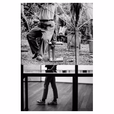 photographie des jambes d'une personne passant derrière un tableau dans un musée