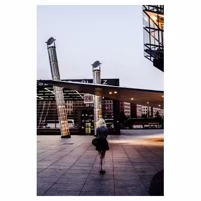 femme de dos seule sur une place fréquentée de Berlin